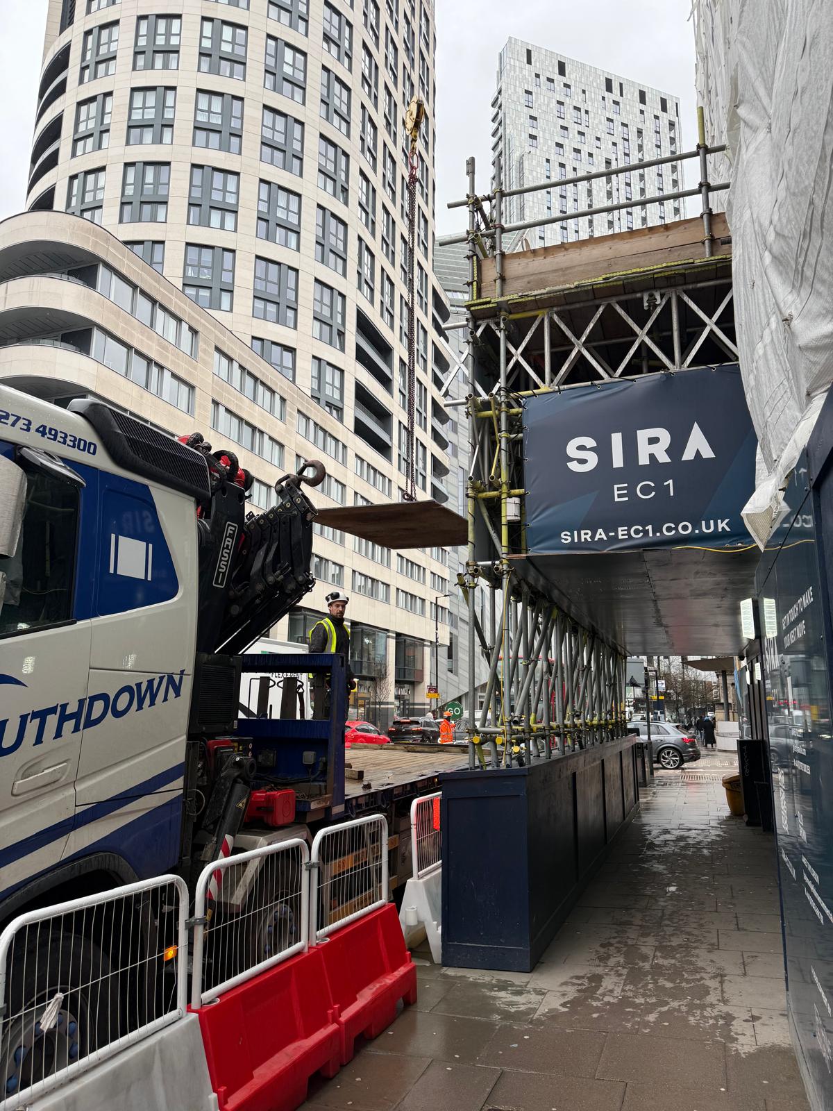The Southdown team commence the lift of the road plate over a busy London street